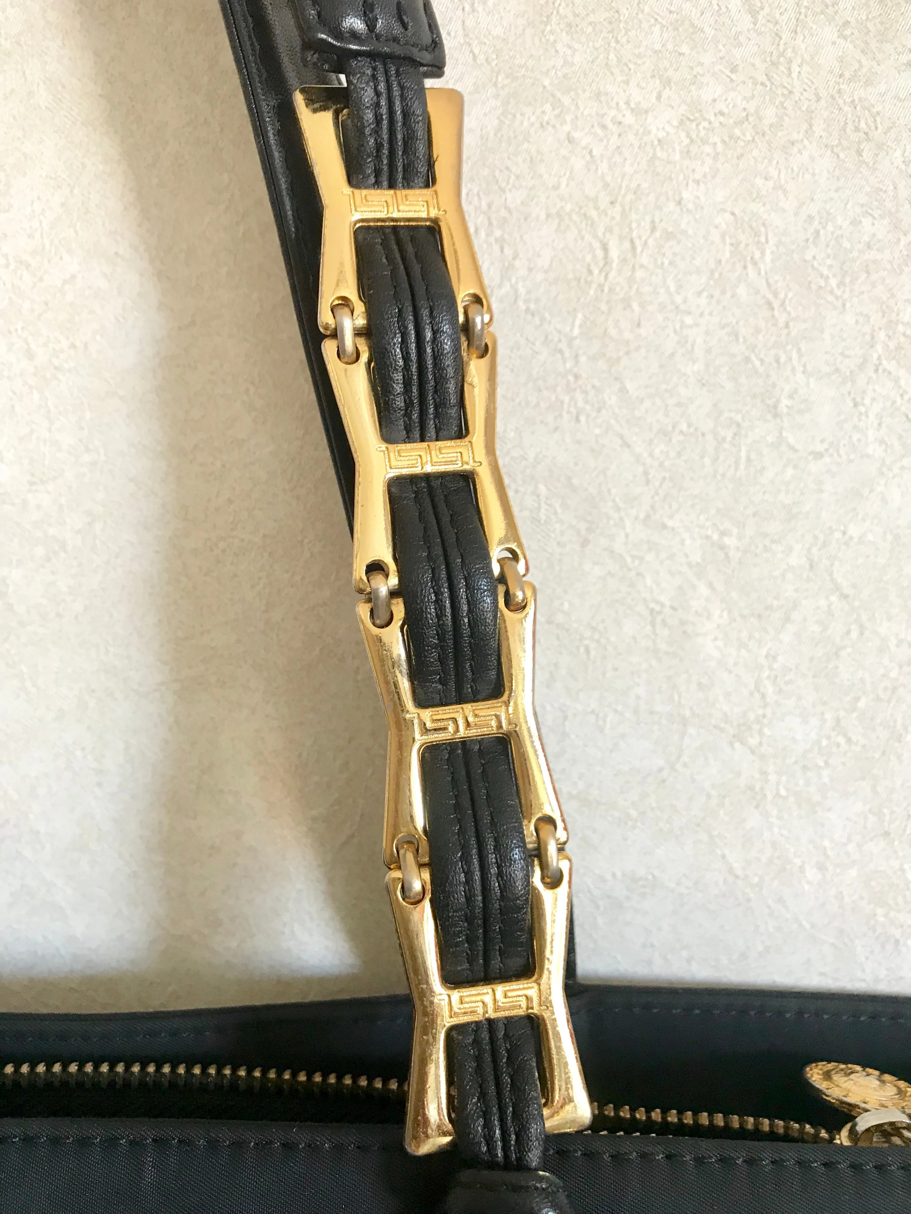 Vintage Gianni Versace large black nylon and leather combination tote bag with gold tone sunburst motifs and chains. 050425r4