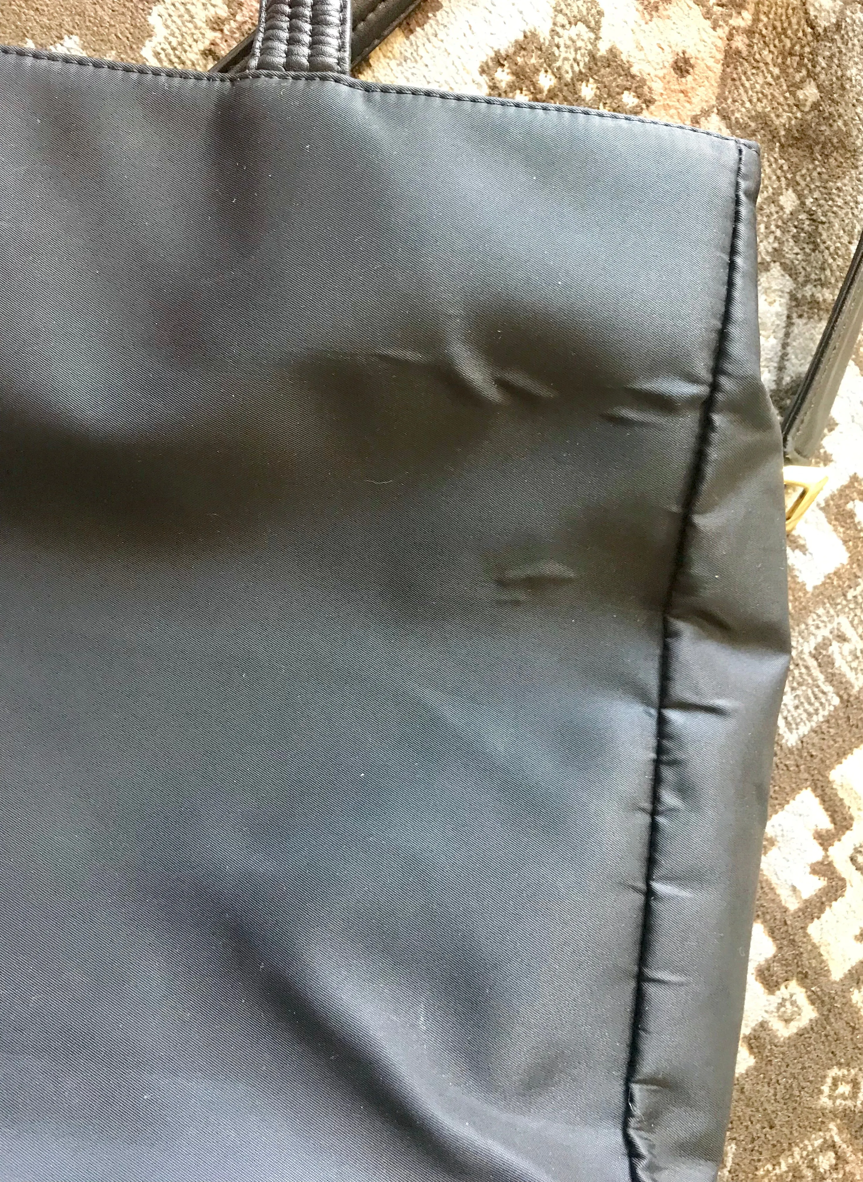 Vintage Gianni Versace large black nylon and leather combination tote bag with gold tone sunburst motifs and chains. 050425r4
