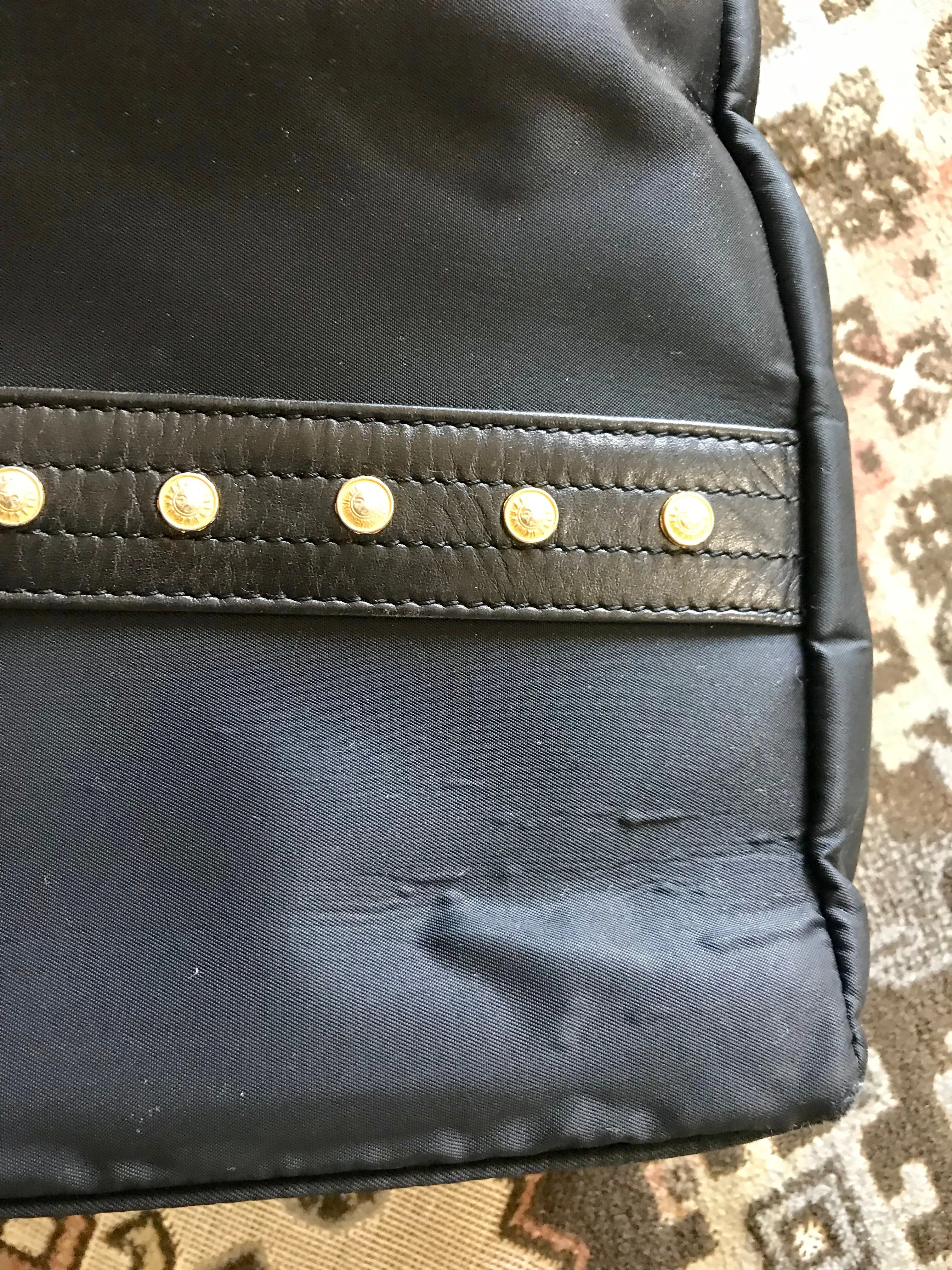 Vintage Gianni Versace large black nylon and leather combination tote bag with gold tone sunburst motifs and chains. 050425r4