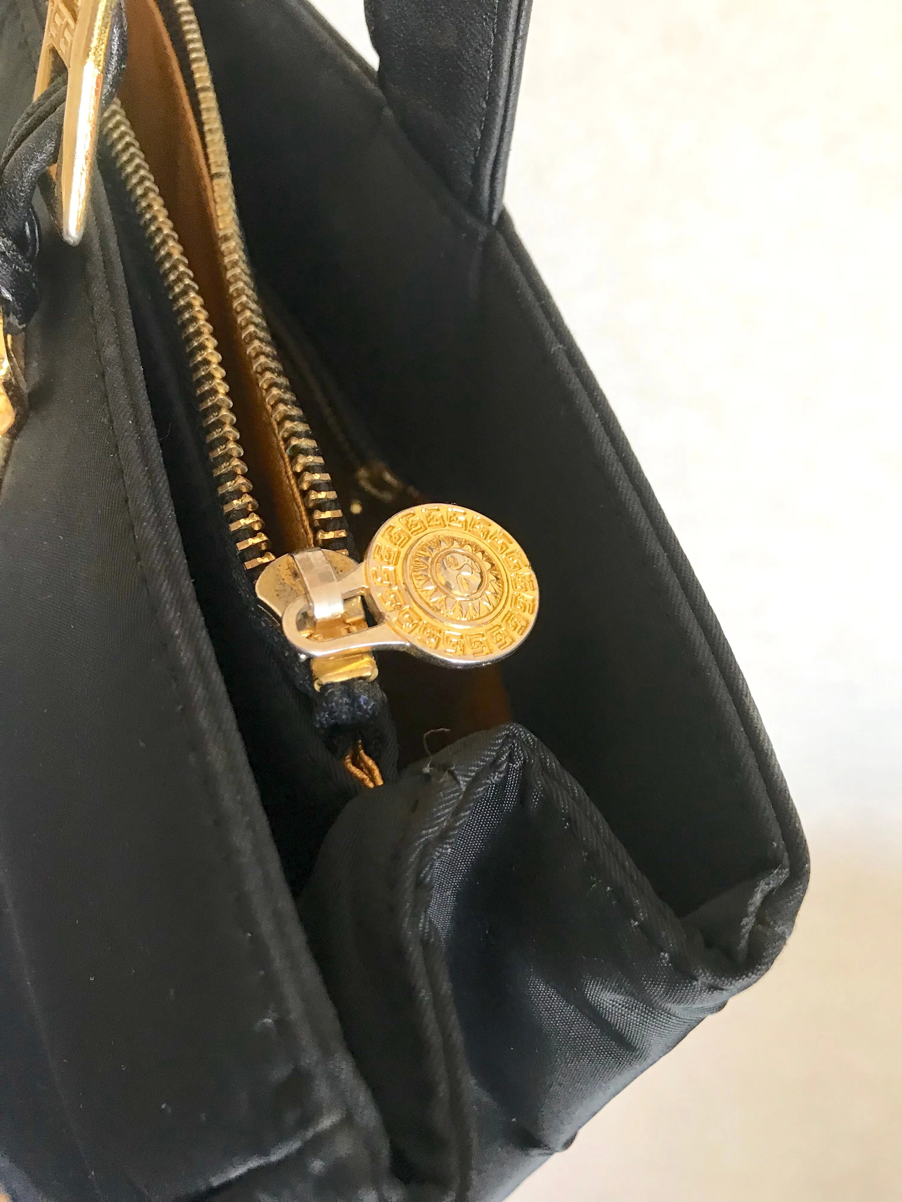 Vintage Gianni Versace large black nylon and leather combination tote bag with gold tone sunburst motifs and chains. 050425r4