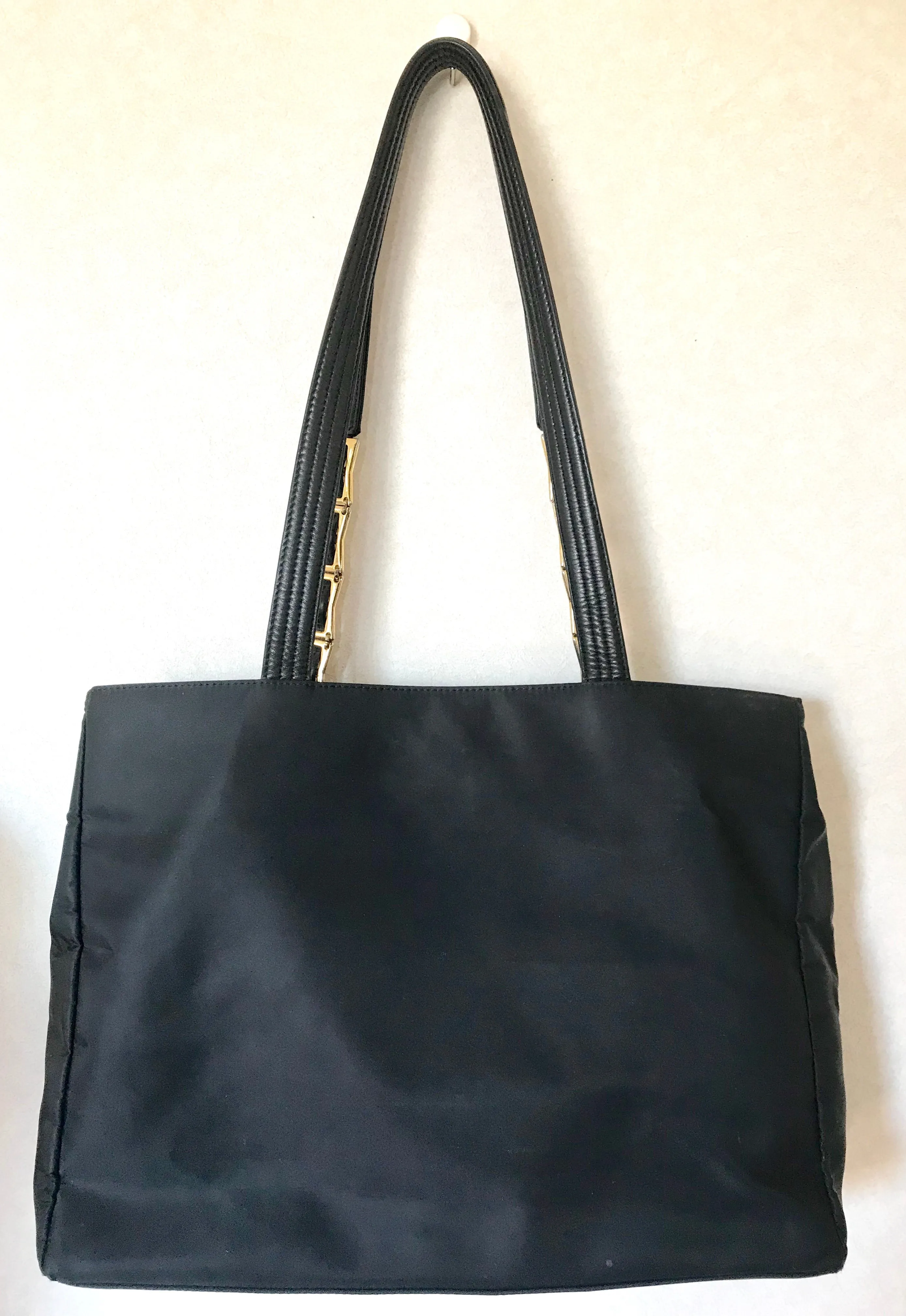 Vintage Gianni Versace large black nylon and leather combination tote bag with gold tone sunburst motifs and chains. 050425r4