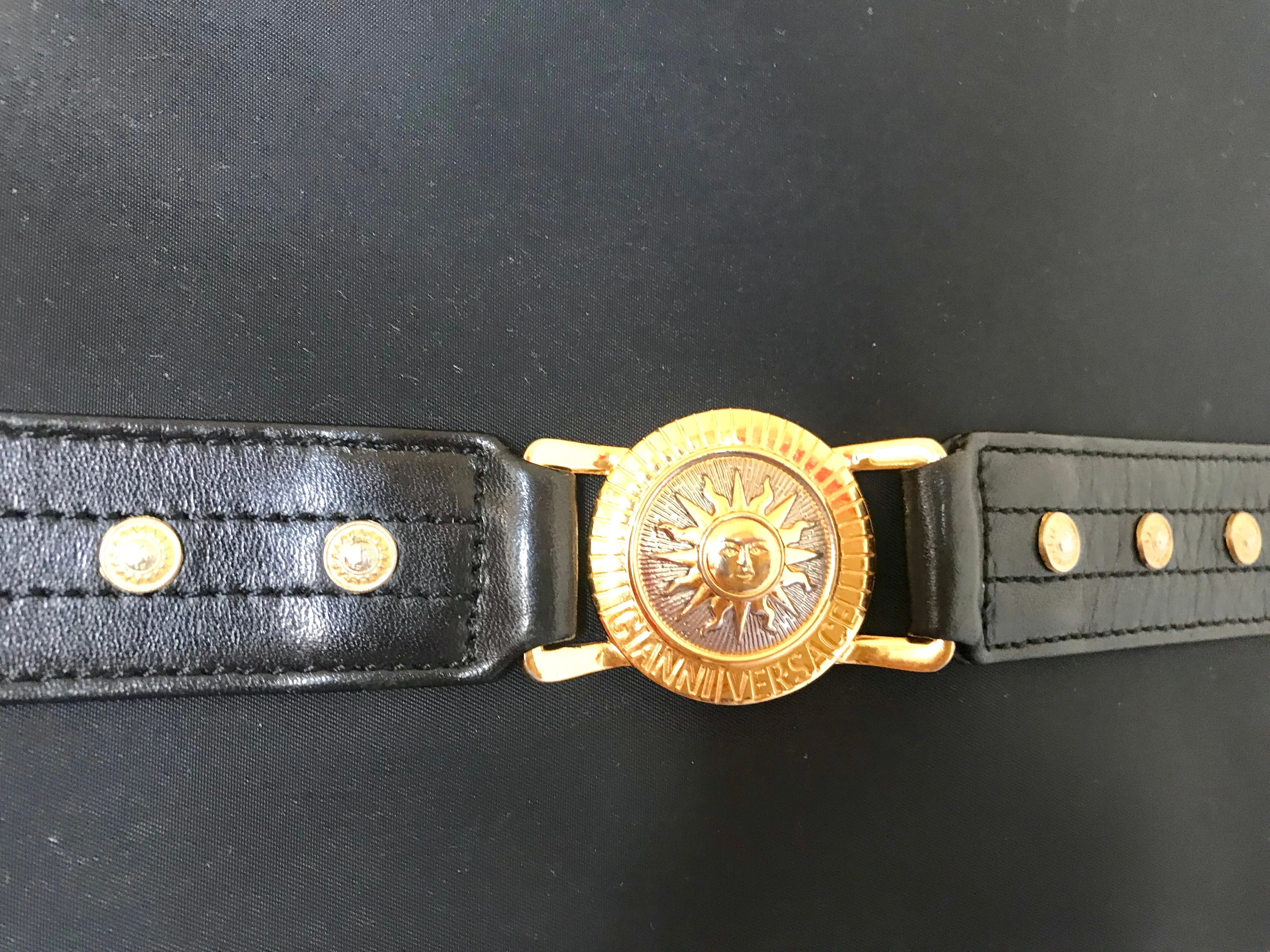 Vintage Gianni Versace large black nylon and leather combination tote bag with gold tone sunburst motifs and chains. 050425r4