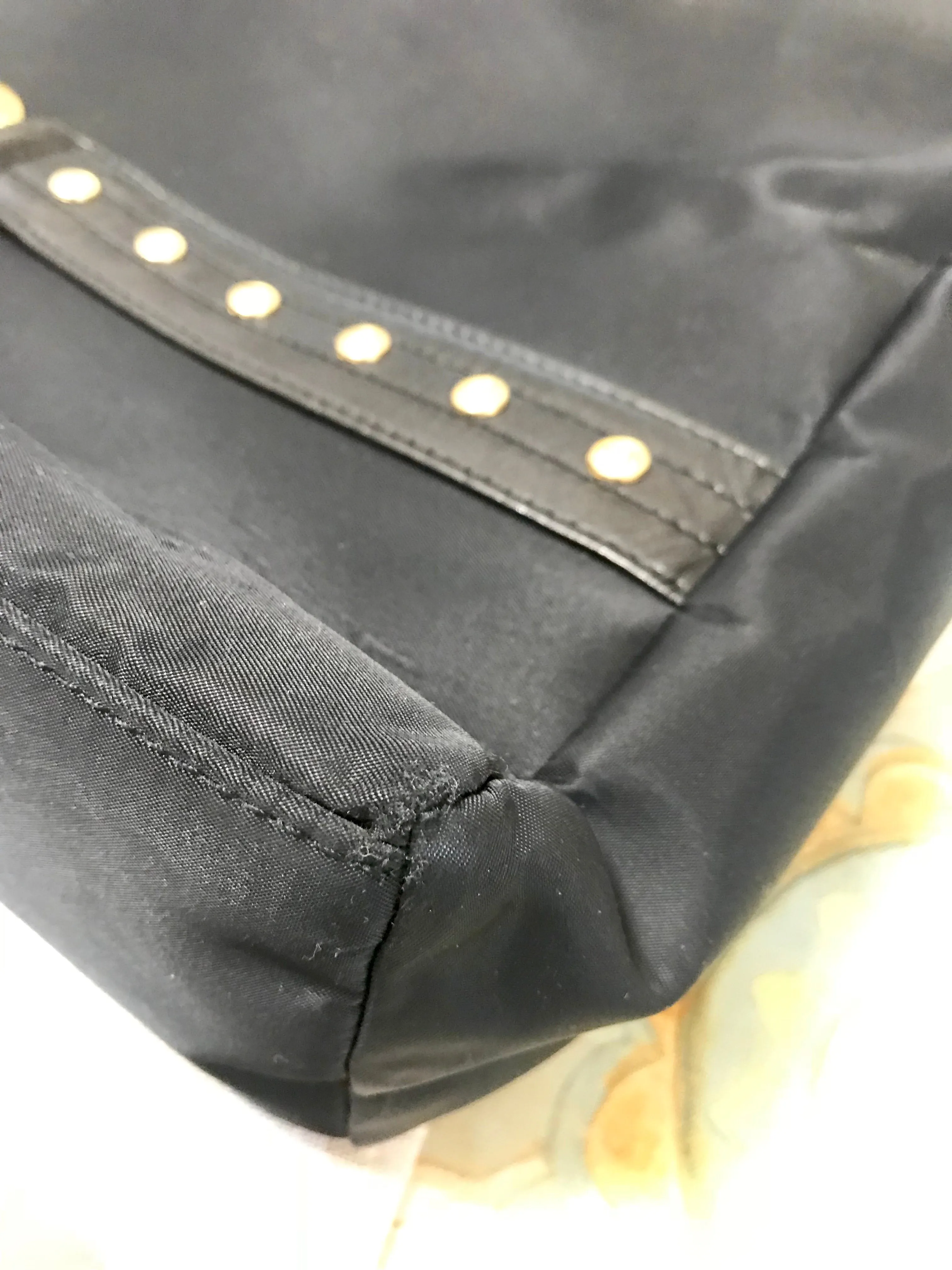 Vintage Gianni Versace large black nylon and leather combination tote bag with gold tone sunburst motifs and chains. 050425r4